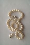A row of non-nucleated freshwater cultured pearls, to a magnetic sphere shaped clasp, 43cm long,