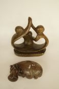 Two carved stone figures including a hippo