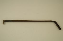 A riding crop with white metal mark