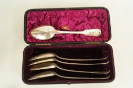 A cased matched set of five Georgian silver fiddle pattern table spoons; four by Eley, Fearn and