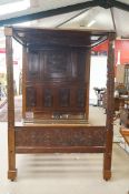 A 19th century oak carved four poster bed