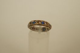 A 9ct gold synthetic stone set eternity ring, finger size M 1/2, 3.1g gross