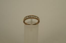 An eight stone cubic zirconia 9ct gold ring, the stones channel set, finger size N, 1.7 grams gross
