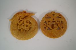 Two carved jade pendants.
