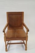 A 20th century oak carved armchair