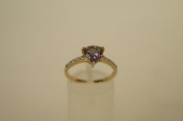 A mystic topaz and diamond 9ct gold ring, the triangular cut stone between shoulders set with a line