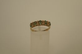 A diamond and emerald 9ct gold half hoop ring, the fine pairs of emeralds with pairs of single