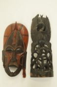A tribal mask along with a carved figure