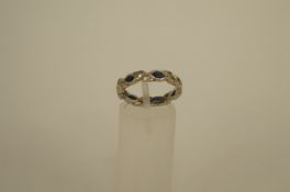 A 9ct white gold synthetic stone set eternity ring, finger size M 1/2 3g gross