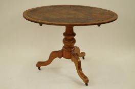 An oval table with leather insert