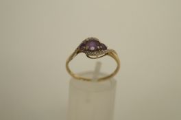 An amethyst and diamond 9ct gold ring, the three graduated amethysts to a corner mount set with five