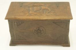 A 20th century oak carved coal bin, decorated with ship