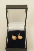 A pair of cameo earrings, stamped '9ct'