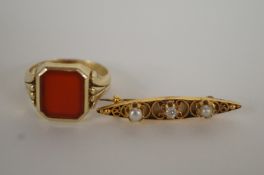 A gentleman's cornelian set ring, stamped '585', 4.9 grams, with a diamond and seed pearl three
