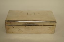 A silver cigarette box, wood lined, 18cm long