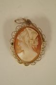 A 9ct gold shell cameo brooch with a wire work frame 4.3cm long