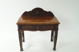 A Victorian oak carved side table