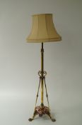 A 20th century brass standard lamp with a copper base