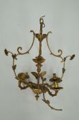 A brass chandelier light fitting
