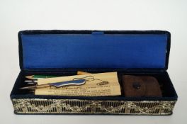 A pin cushion together with various contents including pens, pencils, monocle, pen knife etc.