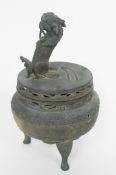 A small bronze incense burner with temple dog on lid