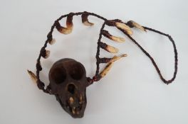 A crab eating monkey skull necklace with wild boar teeth