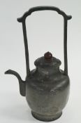 An oriental teapot, pewter and seal mark to the base
