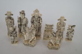 A collection of various ivory chess pieces, some with seal mark to the base