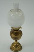 A brass oil lamp with chimney