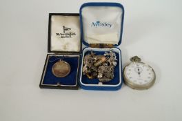 A silver charm bracelet, silver medal and pocket watch