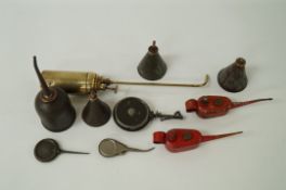 A collection of Oil Cans and a leather cartridge holder