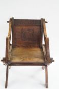 An early 20th century oak Glastonbury chair