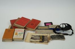A box of postcards, photos, travel books plus an early viewer and glass slides