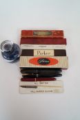 Five boxed fountain pens plus three others, silver dip pen and a glass inkwell.