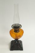 A glass and cast-iron based oil lamp