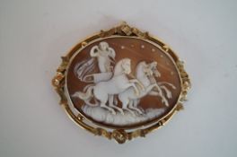 A large cameo brooch in a yellow metal mount