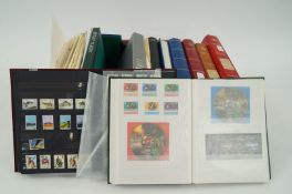 A collection of stamps in 12 stock books and loose Guernsey, Jersey