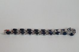 A 9ct white gold and topaz bracelet