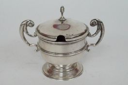 A silver mustard pot