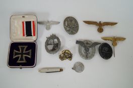 A collection of various Nazi badges