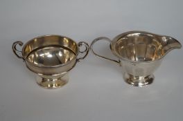 A silver cream jug and bowl