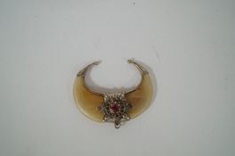 A double tigers claw brooch with white metal mount