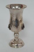 A silver vase with grapes