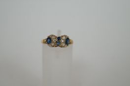 An 18ct gold ring set with sapphires and diamonds