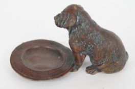 A bronze figure of a puppy stamped "Geschutzt"