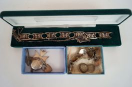A collection of various silver items, including 2 bracelets, lockets