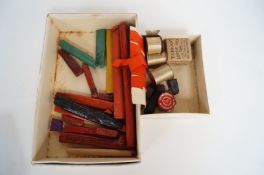 A box of sealing wax and ribbons