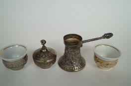 A Yugoslavian coffee set in pressed metal with china cups