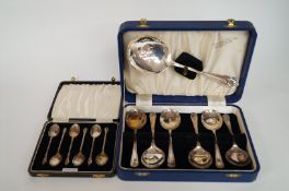 A box of silver teaspoons and a boxed dessert spoon set