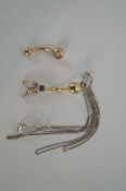 Two 9ct gold belly bars and 9ct white gold pendant and chain